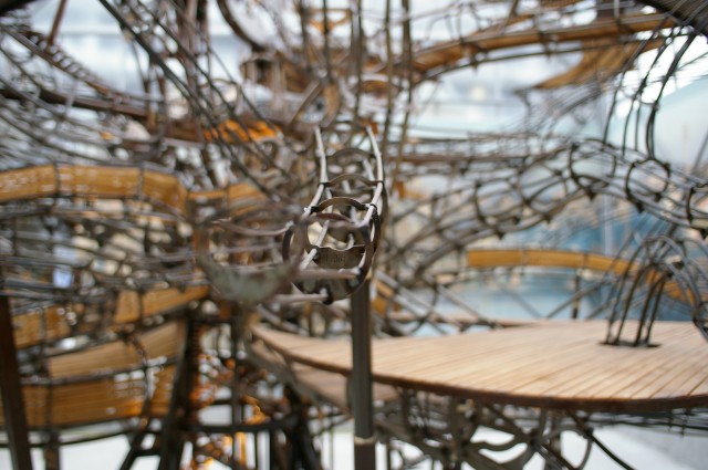 Image illustrant l'article. Photo avec focus centré sur le milieu d'une branche d'une maquette de l'arbre aux hérons, avec des passerelles en bois visibles.